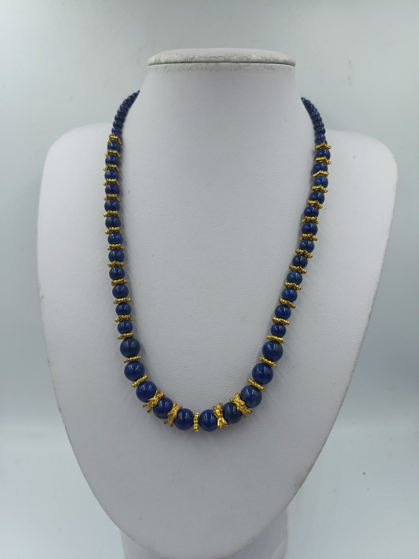 Blaue Perlenkette mit goldfarbenen Zierelementen und klassischem eleganten Look