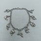 Silbernes Charm Armband aus 925 Silber mit Delfin Motiven und verspieltem Design