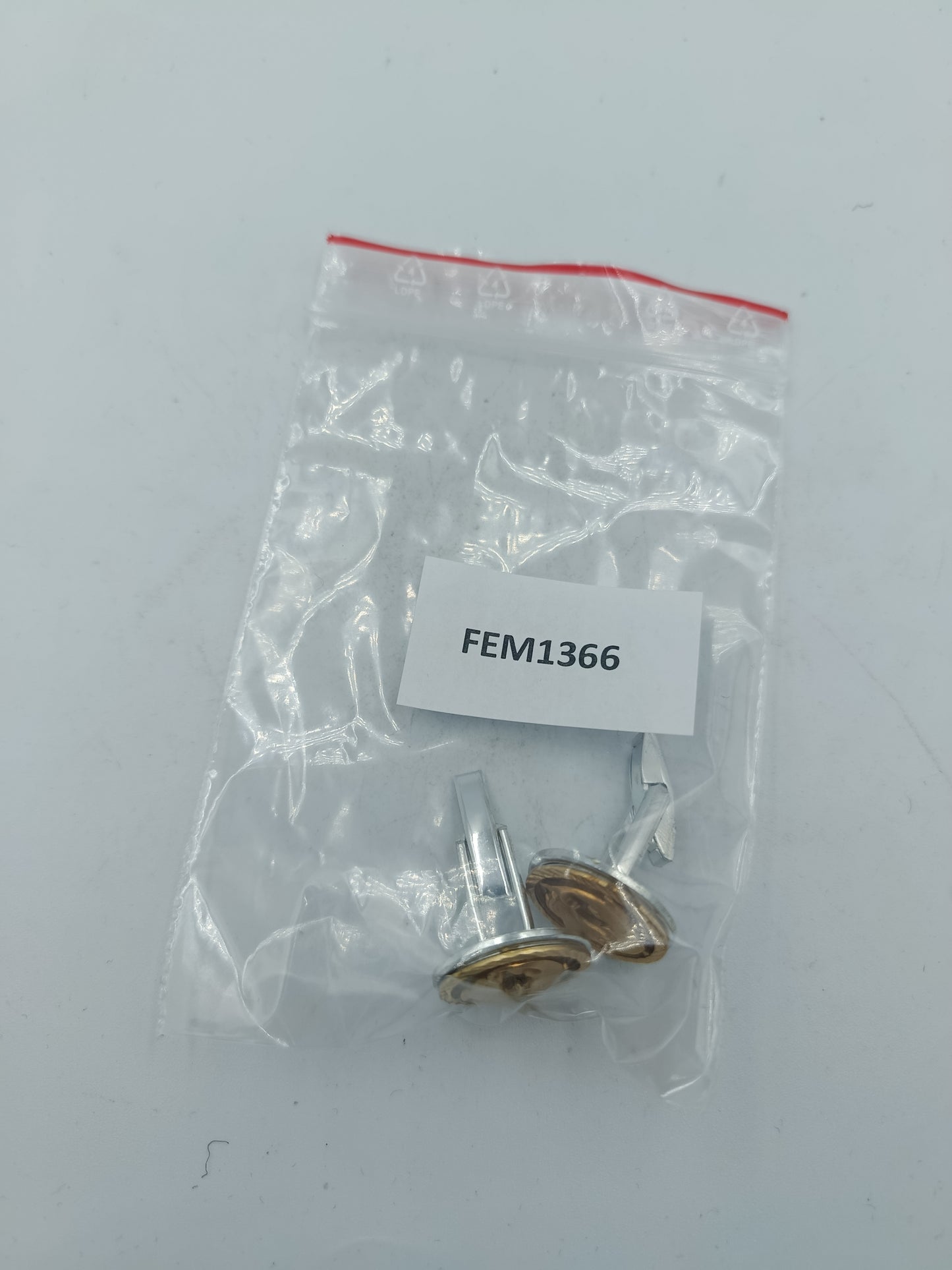 Goldfarbene Manschettenknöpfe mit Delfin Motiv und strukturierter Umrandung