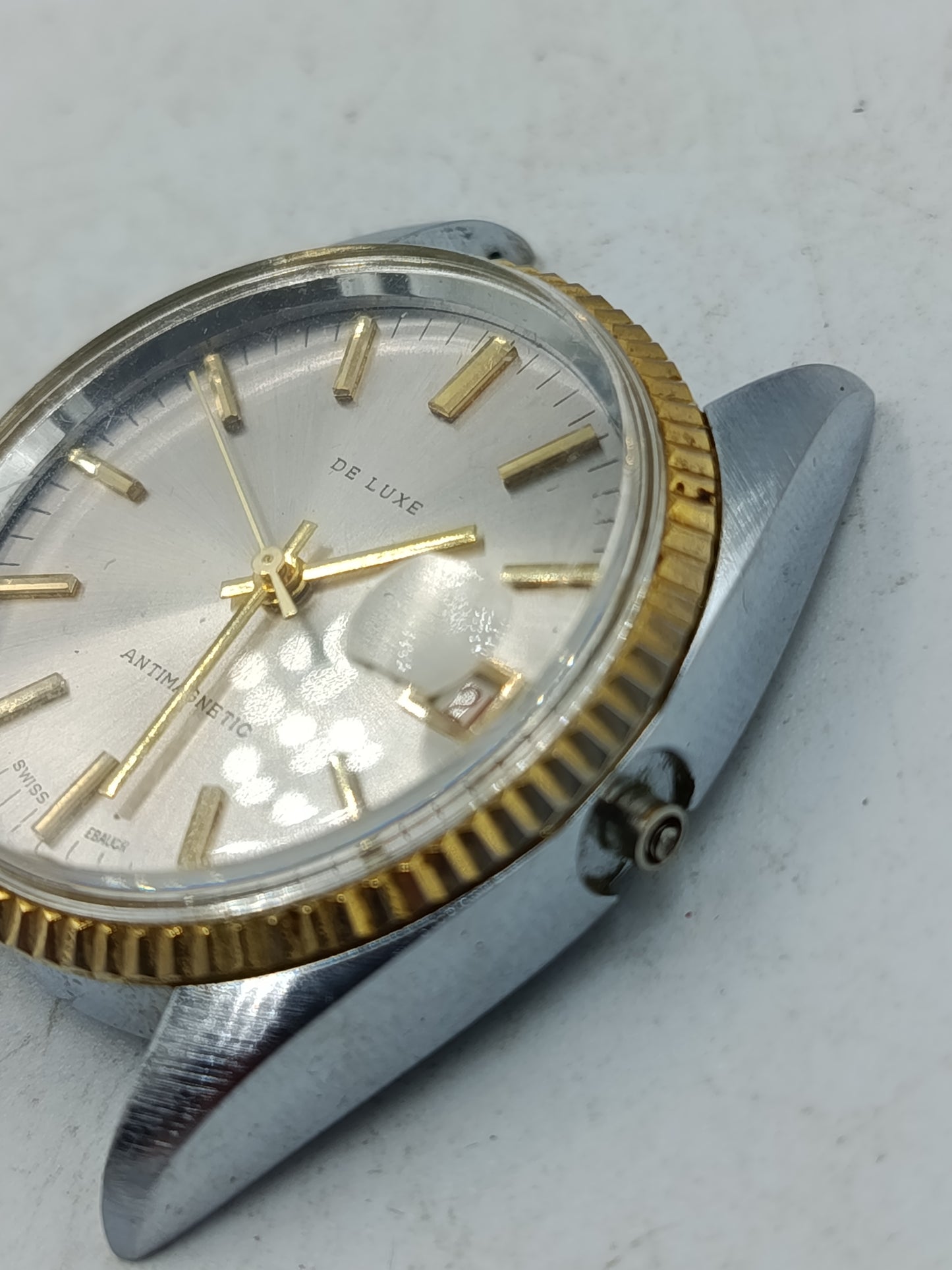 Klassische Schweizer Armbanduhr De Luxe mit goldfarbener Lünette