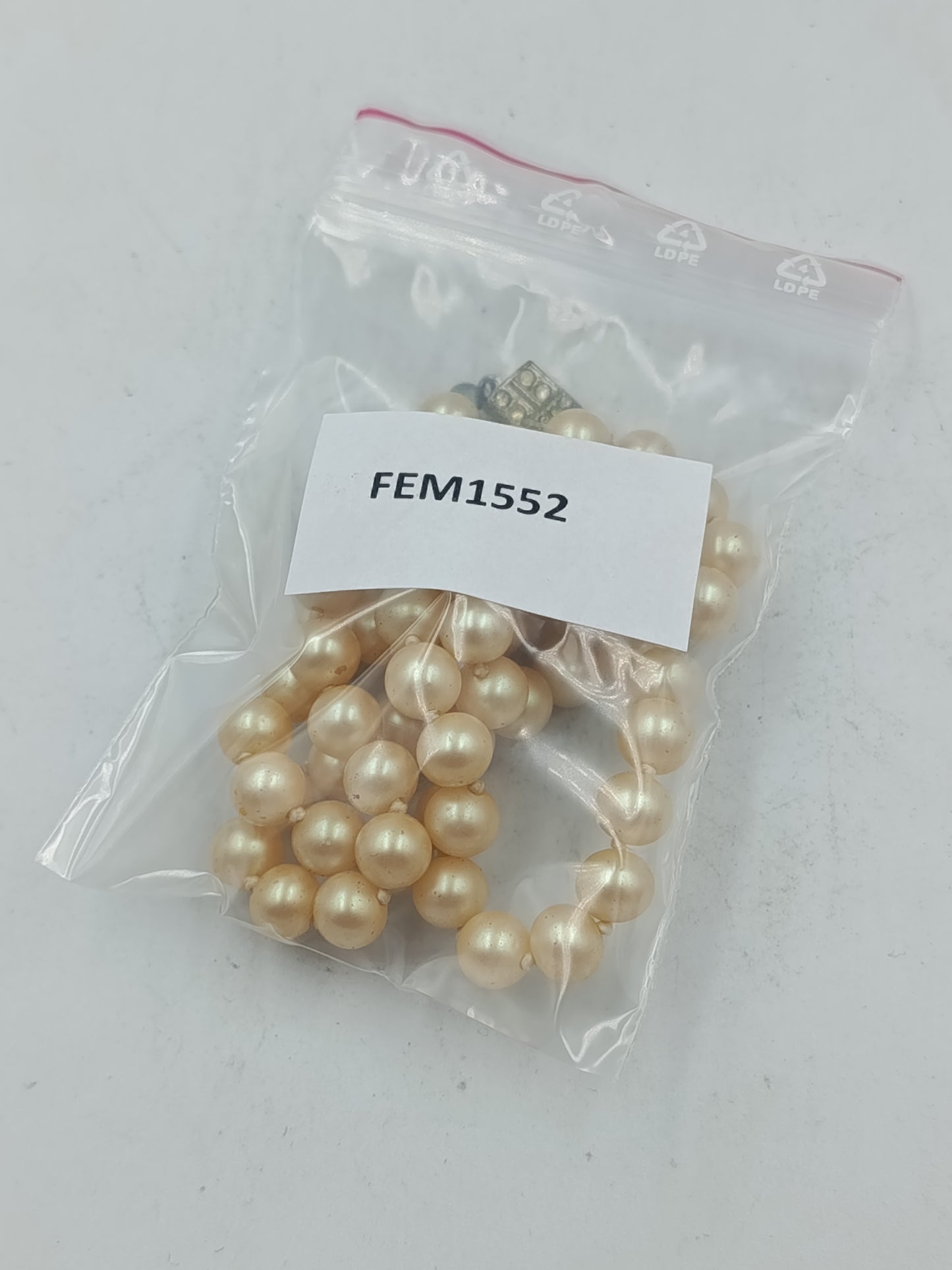 Klassische Perlenkette in sanftem Cremeton mit dekorativem Schmuckverschluss aus Metall