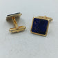 Elegante Manschettenknöpfe in Goldoptik mit tiefblauem Steineinsatz im klassischen Stil