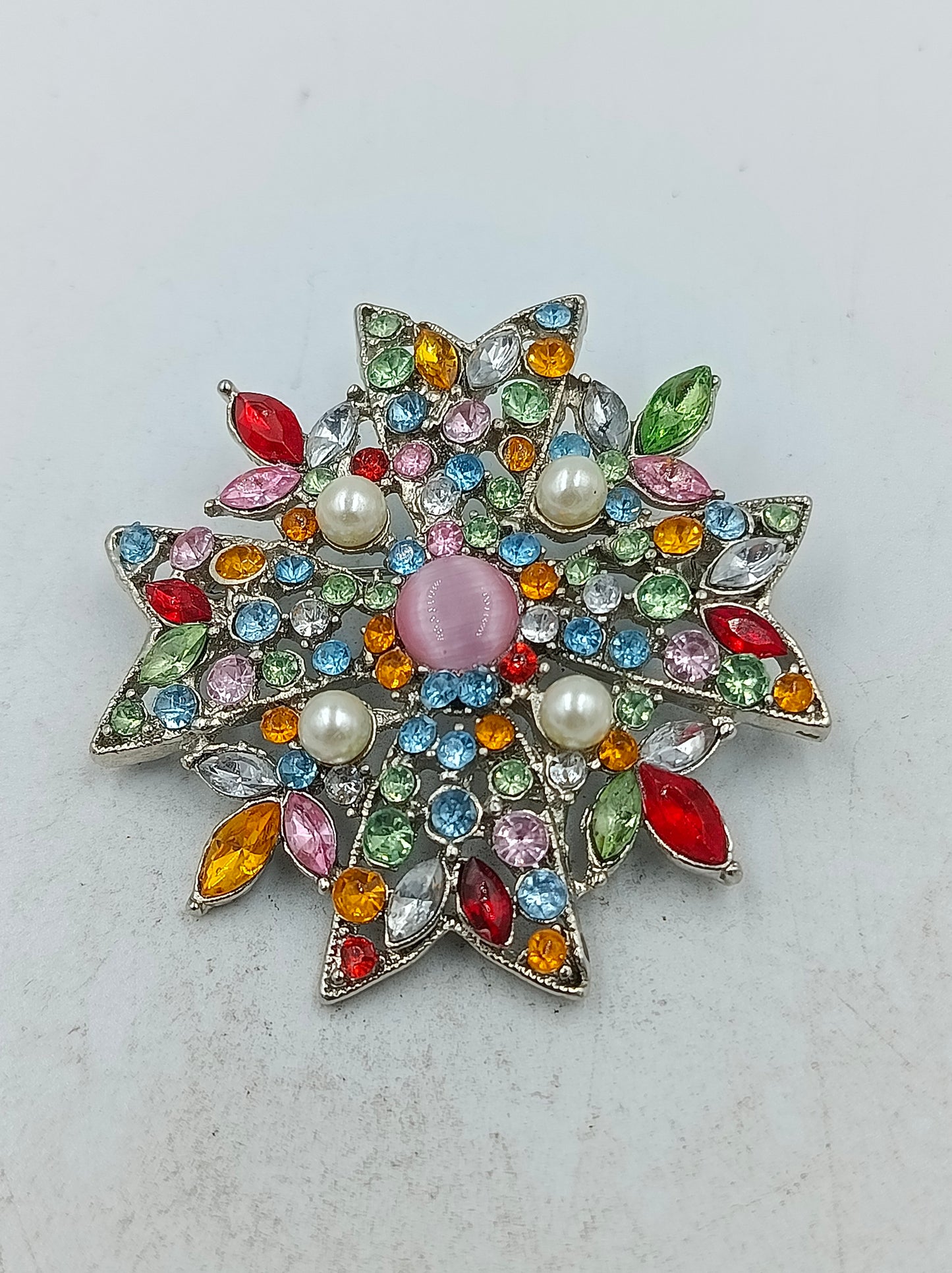 Auffällige Stern Brosche mit bunten Kristallen und Perlen in eleganter Form