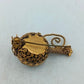 Goldfarbene Brosche mit runder Steinoptik und kunstvollem Vintage Design