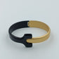 Moderner Armreif in Schwarz und Gold im minimalistischen Design