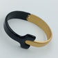 Moderner Armreif in Schwarz und Gold im minimalistischen Design