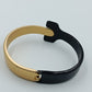 Moderner Armreif in Schwarz und Gold im minimalistischen Design