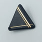 Geometrische Vintage Brosche in Schwarz mit goldenen Linien im Art Déco Stil