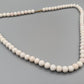 Elegante weiße Perlenkette Halskette mit zartem Roséton